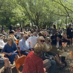 Above: More than 400 people attended a celebration of life for longtime Monument resident Jim Maguire, “the Mayor of Maguireville,” also known to friends as “Jumpin’ Jimmy” and “Brushfire Maguire.” Maguire died May 3 at the age of 96. The ceremony was held outside at his home on a warm and sunny day (in photo). Maguire’s son Kevin remembered his dad as a “collector of friends and stuff.” A lot of stuff. Maguire collected thousands of pieces of memorabilia and stored them in his two barns that he named Maguireville. Kevin also had this to say about his father: “He was a hard worker. He was a good husband. He had a fun-loving spirit, and he truly did hate to miss a party. He had a great sense of humor. He was an easy man to like. He loved people. He was a thoughtful, caring, faithful friend to many. He was always interested in other people’s lives. He was a good father, a supportive husband. He had a mischievous twinkle in his eye.” Maguire’s grandson Tyler Powell also spoke, thanking his “grampy” for being an “inspiration to all of us.” Photo by Michael Weinfeld.