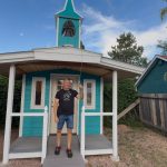 Above: Being an artist, Daryl Muncey, came up with a creative idea when a tree fell on his fence last year; he built a replica of a one-room schoolhouse where he could hang more of his paintings. The bright blue building even comes equipped with a school bell in front that he rang for people who visited during Art Hop on June 27. The building is part of his Jefferson Studios complex at 215 Chapala Plaza in an alley off Second Street. Photo by Michael Weinfeld